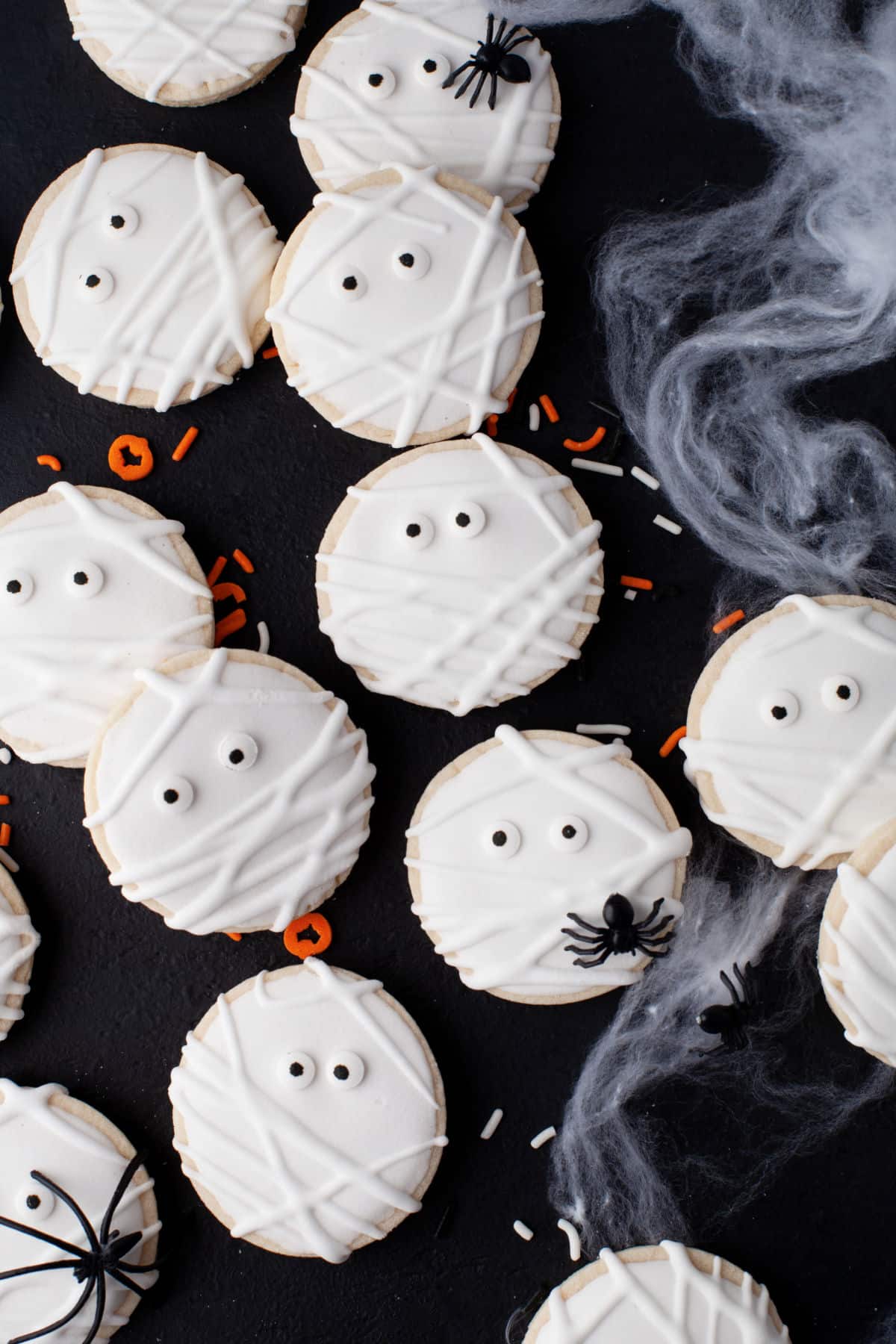 10 Mummy sugar cookies on black background.