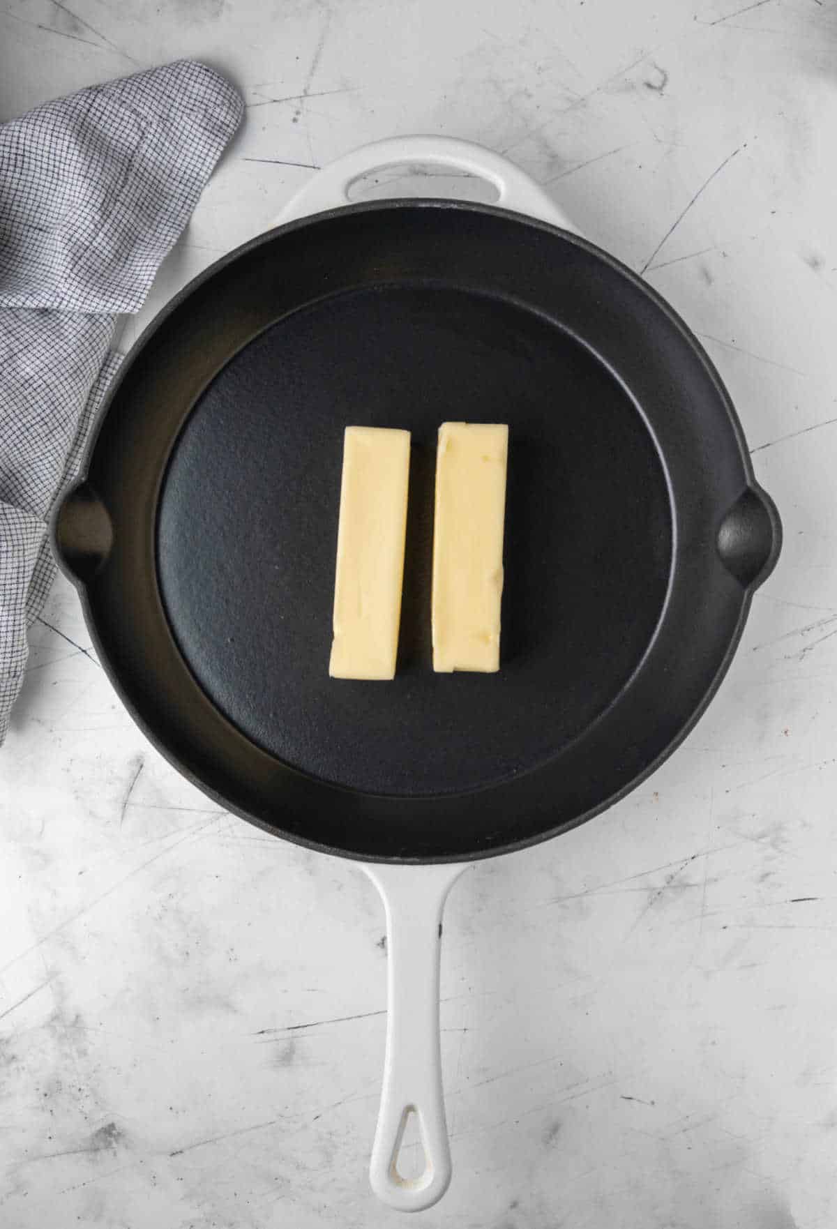 Two sticks of butter in a cast iron skillet. 