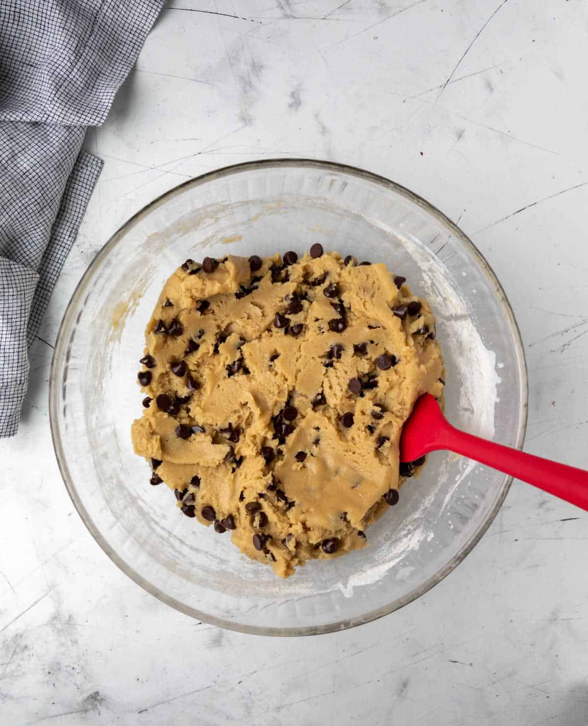 Pizookie dough in a glass mixing bowl. 