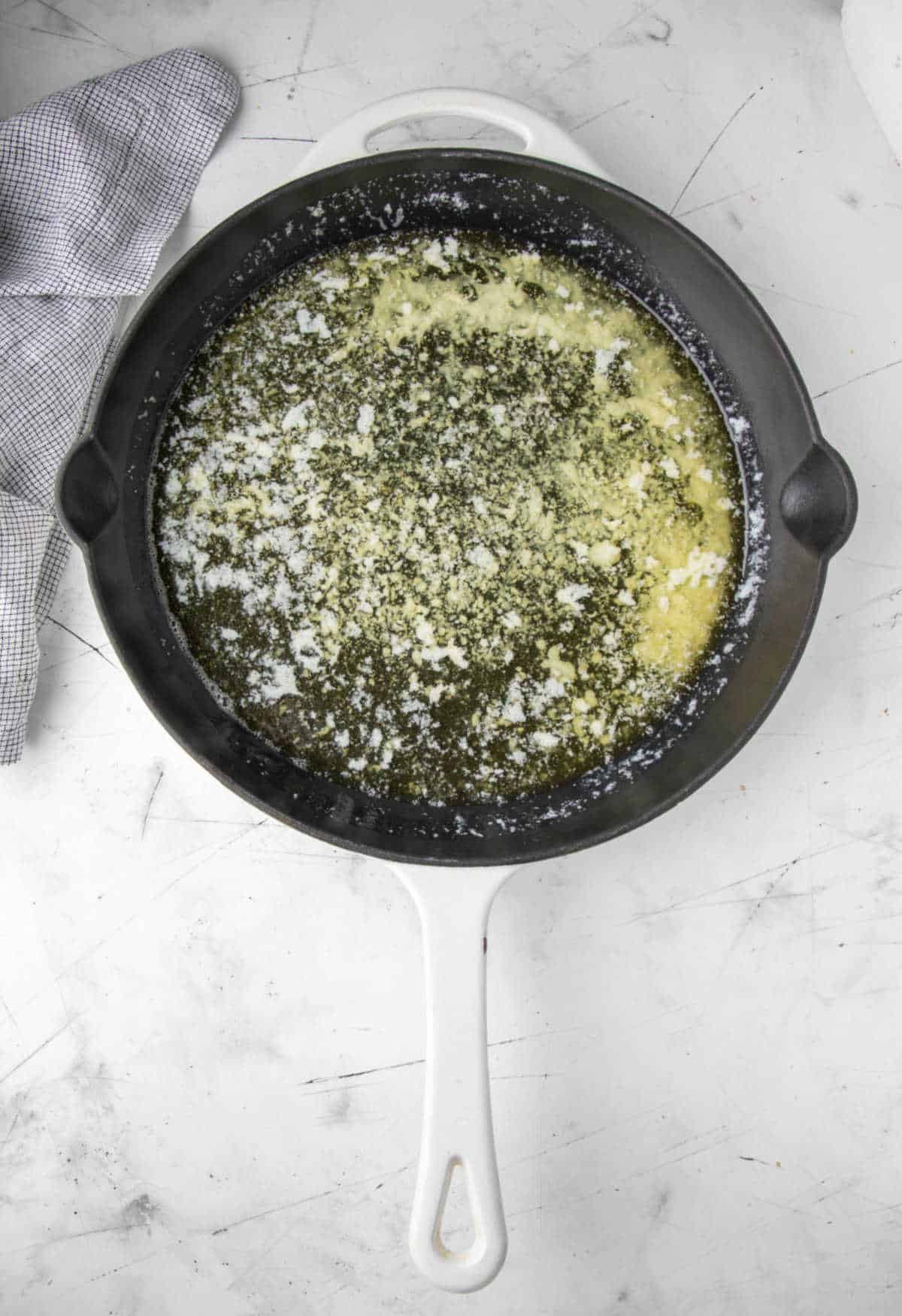 Melted butter in a cast iron skillet. 