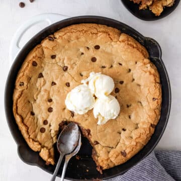 A pizookie topped with three scoops of vanilla ice cream.