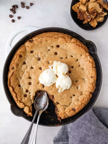 A pizookie topped with three scoops of vanilla ice cream.