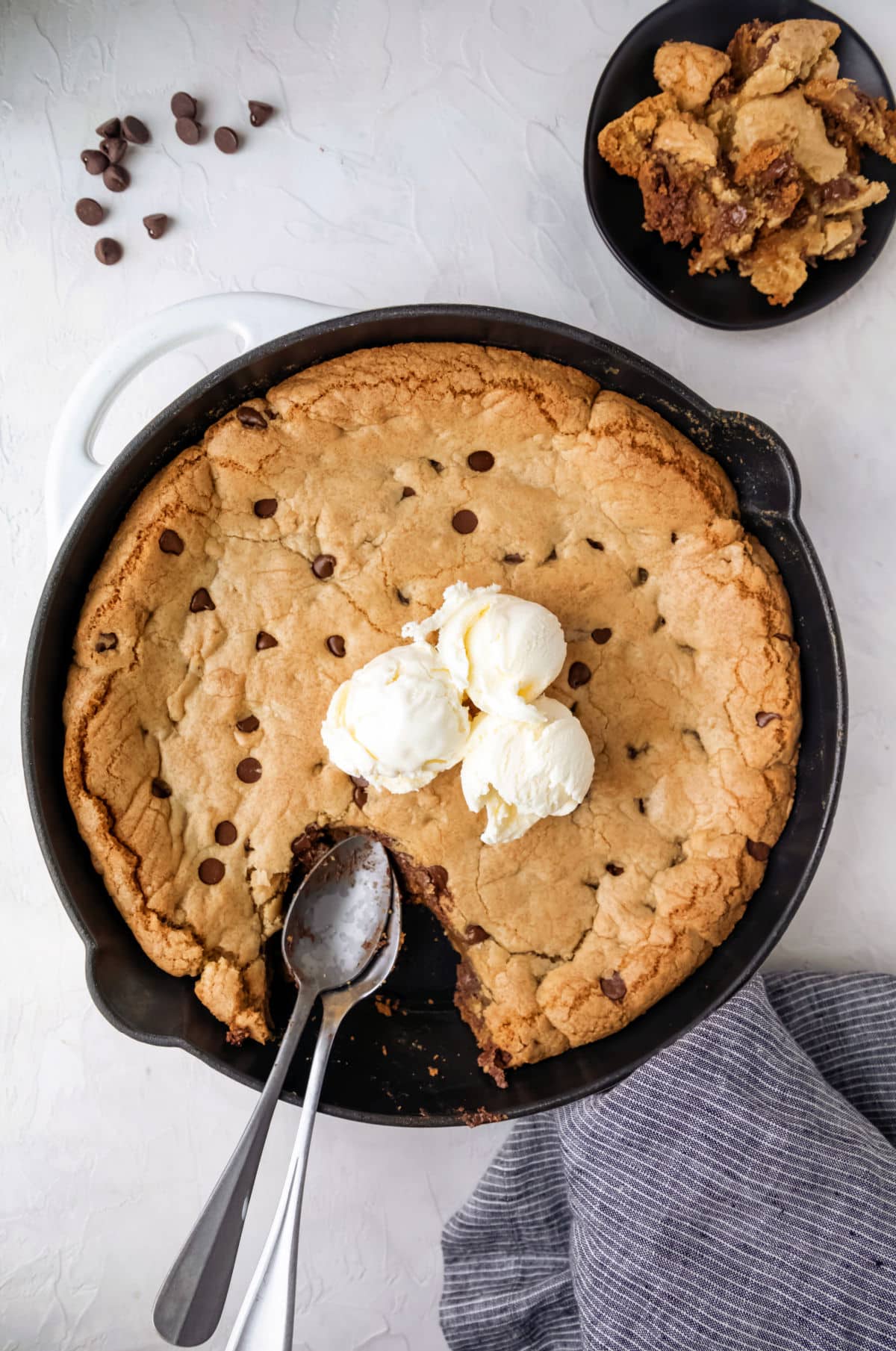 A pizookie topped with three scoops of vanilla ice cream.