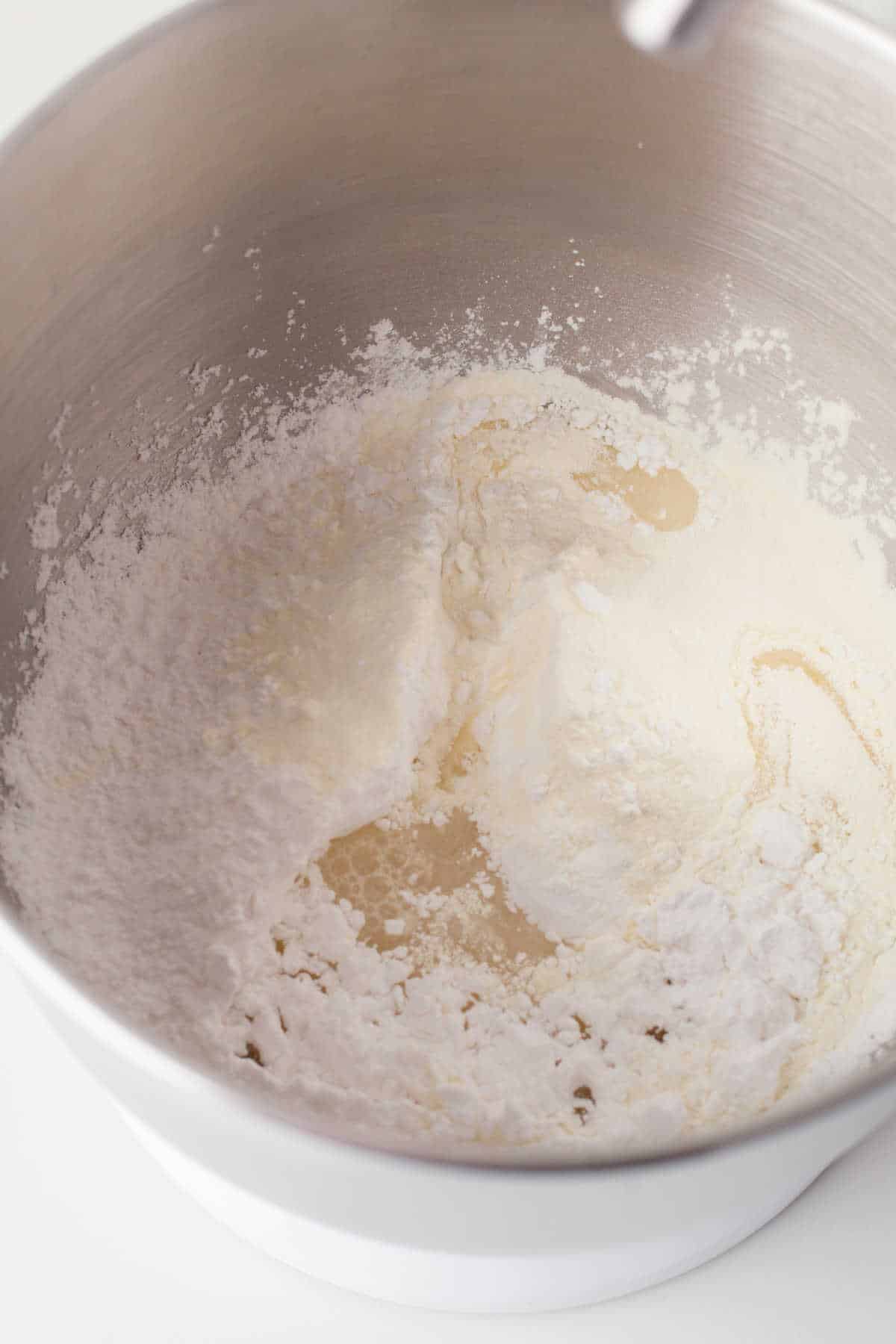 Ingredients for royal icing in the bowl of a stand mixer. 