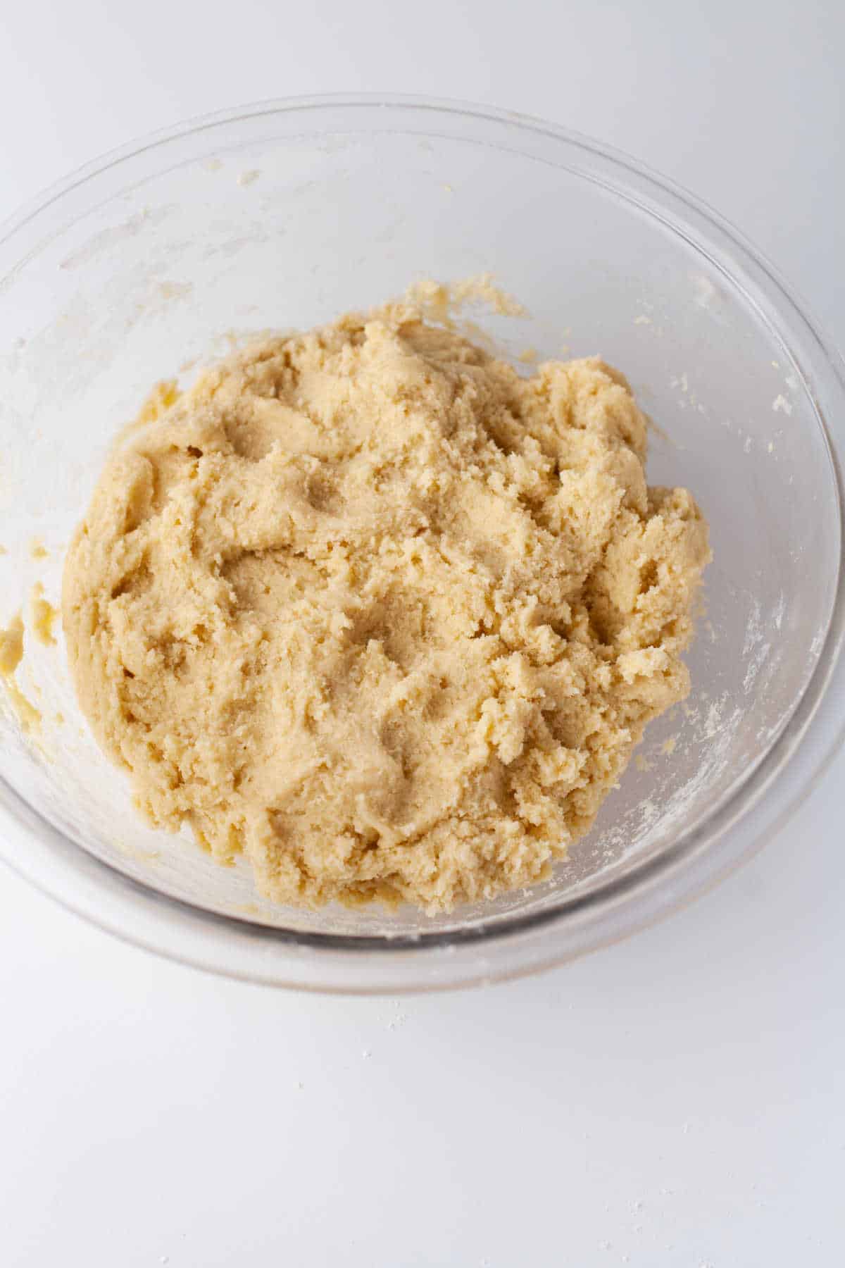 Snickerdoodle cookie dough in a glass mixing bowl. 