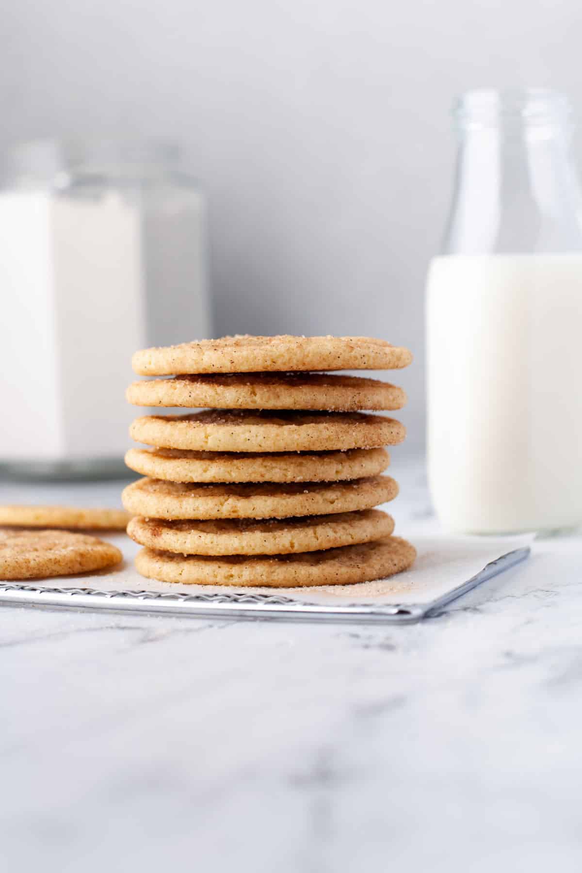 A stack of snickerdoodles on a wire cooling rack. 