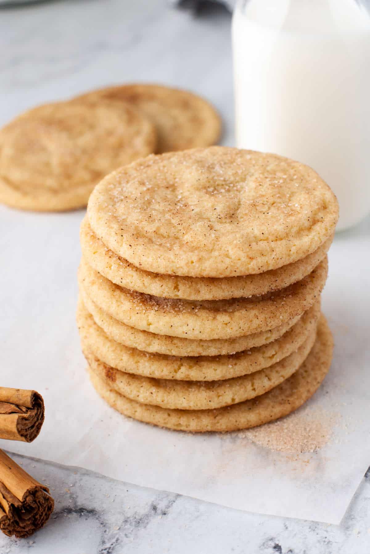 Chewy Snickerdoodle Cookies Stack of snickerdoodle cookies next to a bottle of milk.