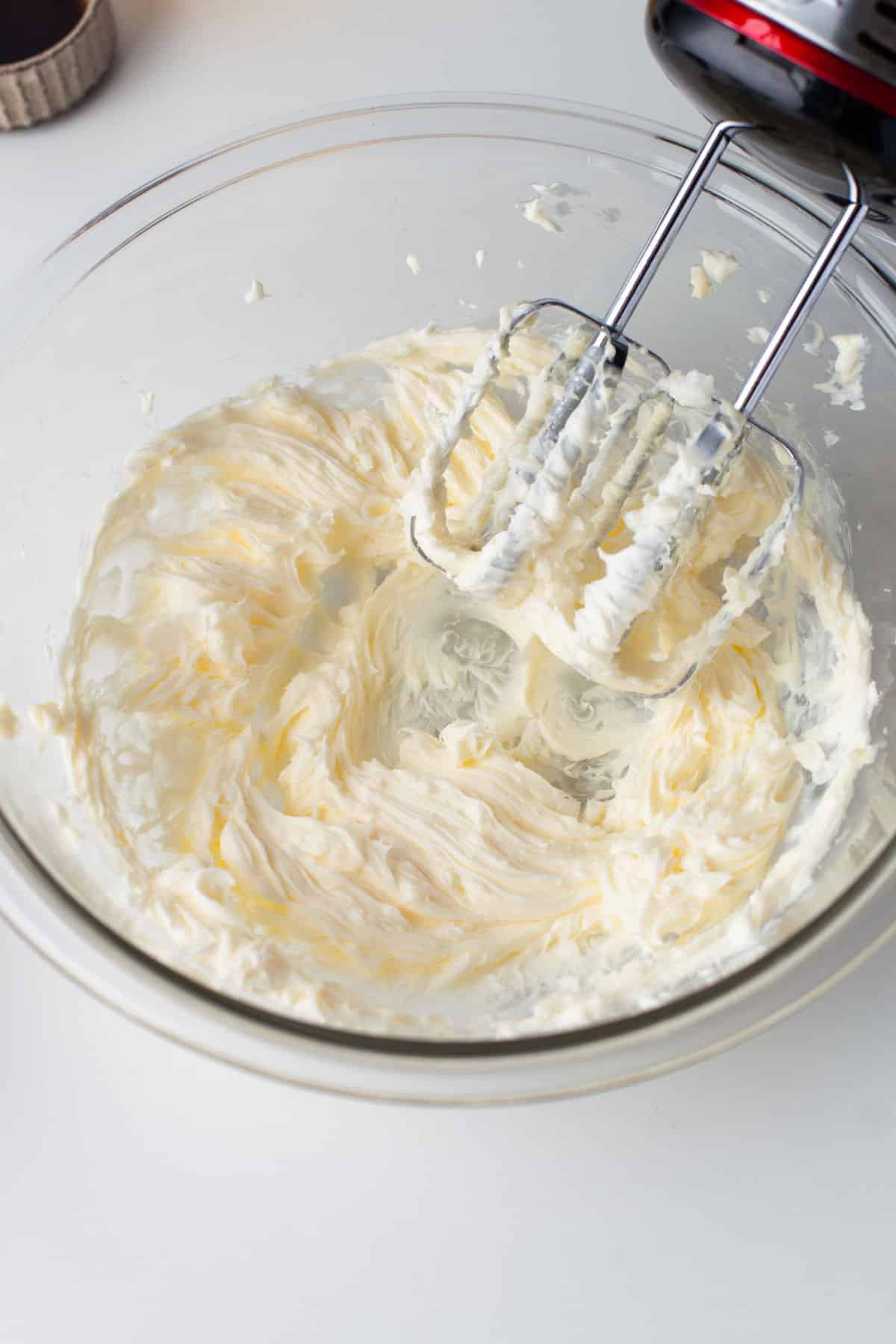 A bowl with beaten butter and shortening in a glass bowl. 