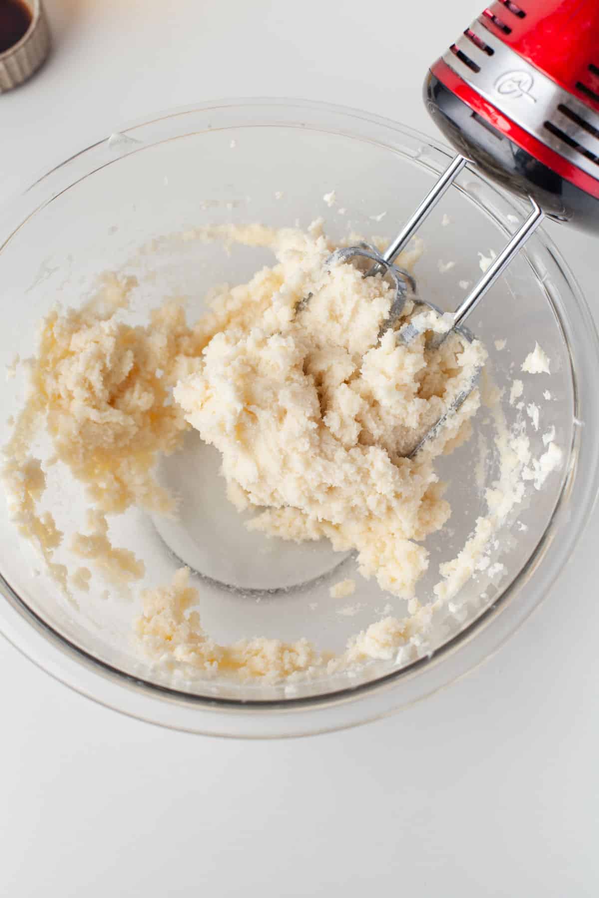 Creamed butter shortening and sugar in a glass mixing bowl.