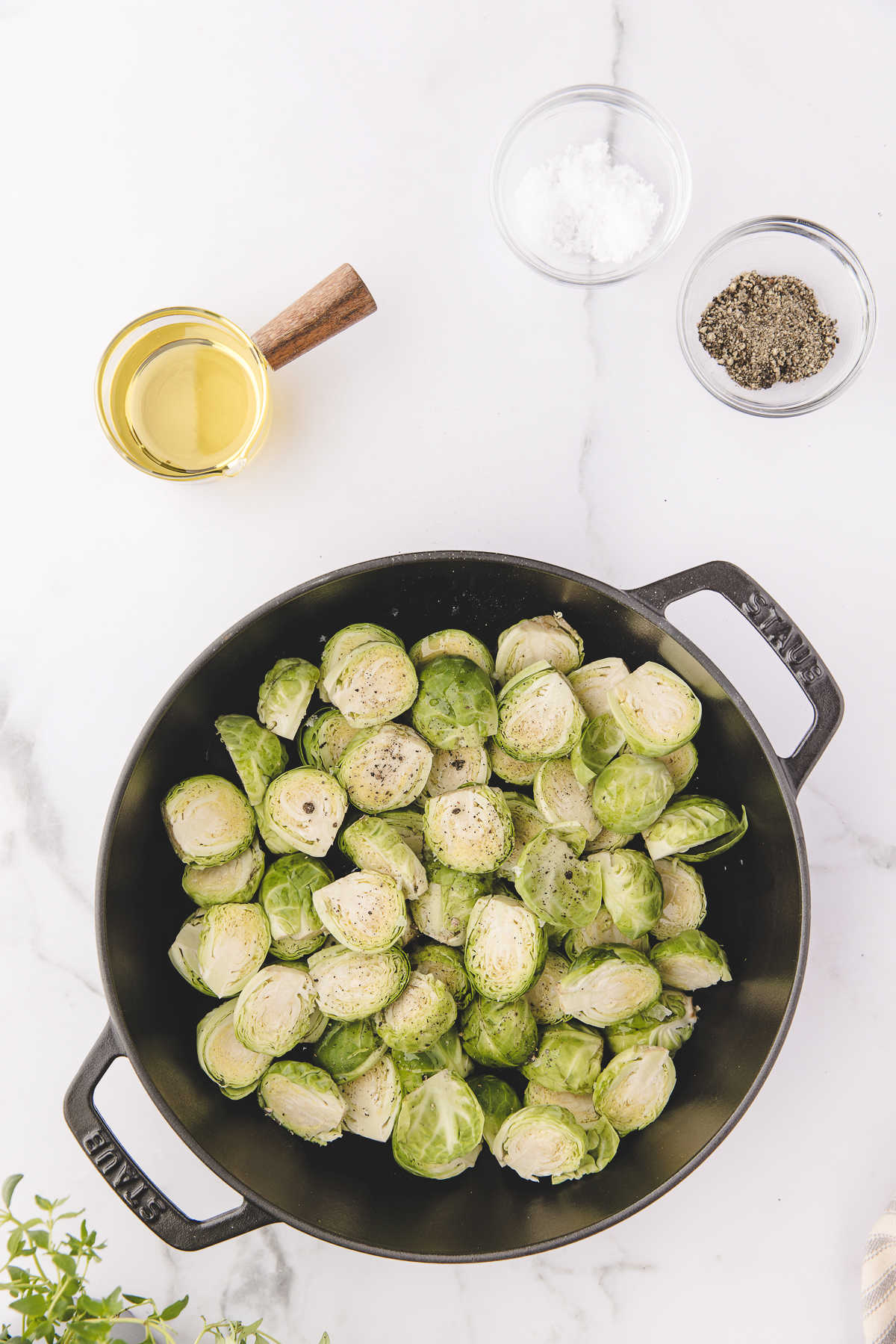 Uncooked Brussels sprouts in a cast iron baking dish. 