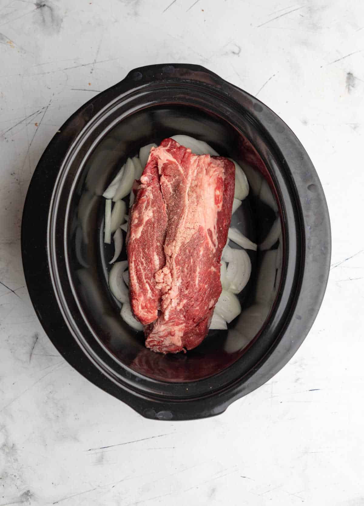 Salt and pepper on a chuck roast in a crock pot. 