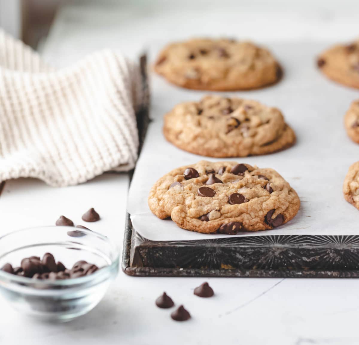 Jumbo chocolate chip cookies on an upside down baking sheet. 