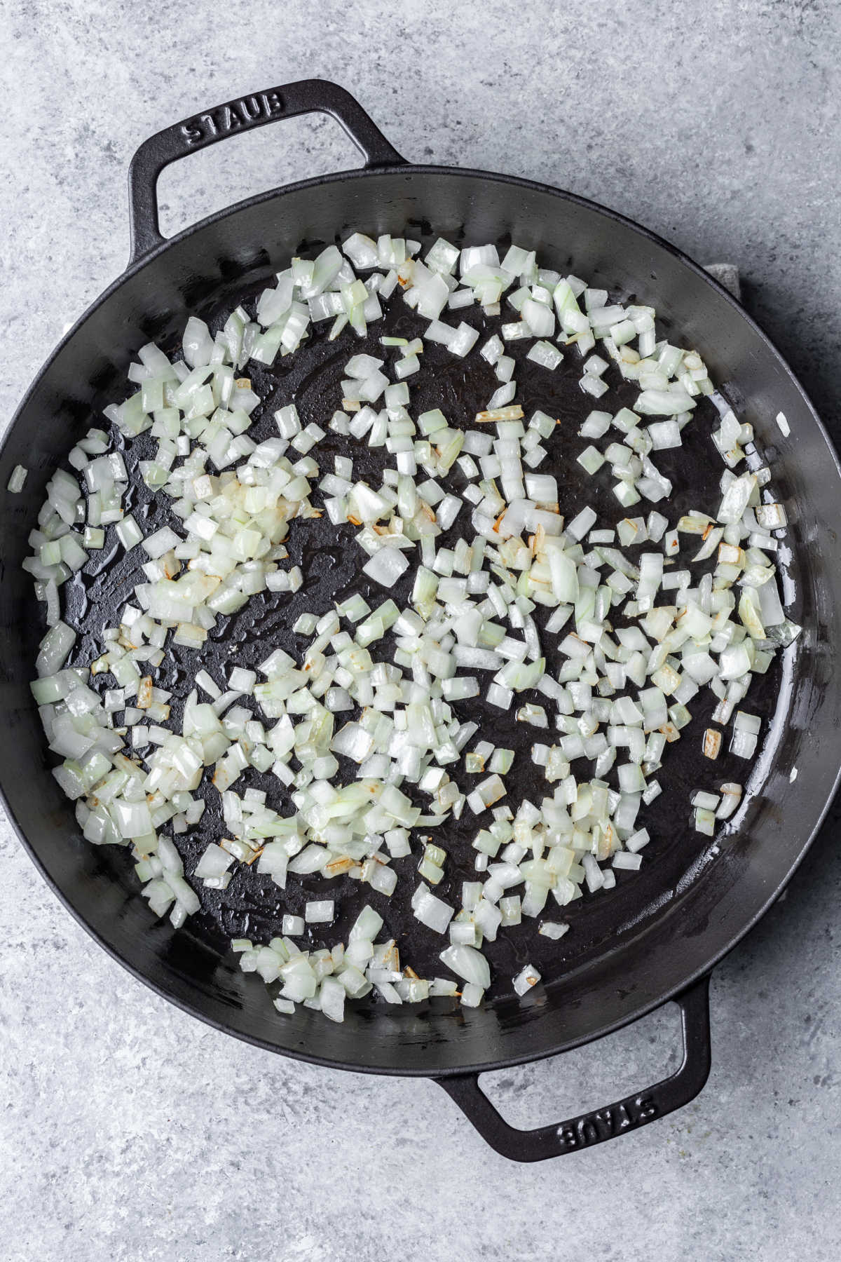 Diced onion in a cast iron skillet. 