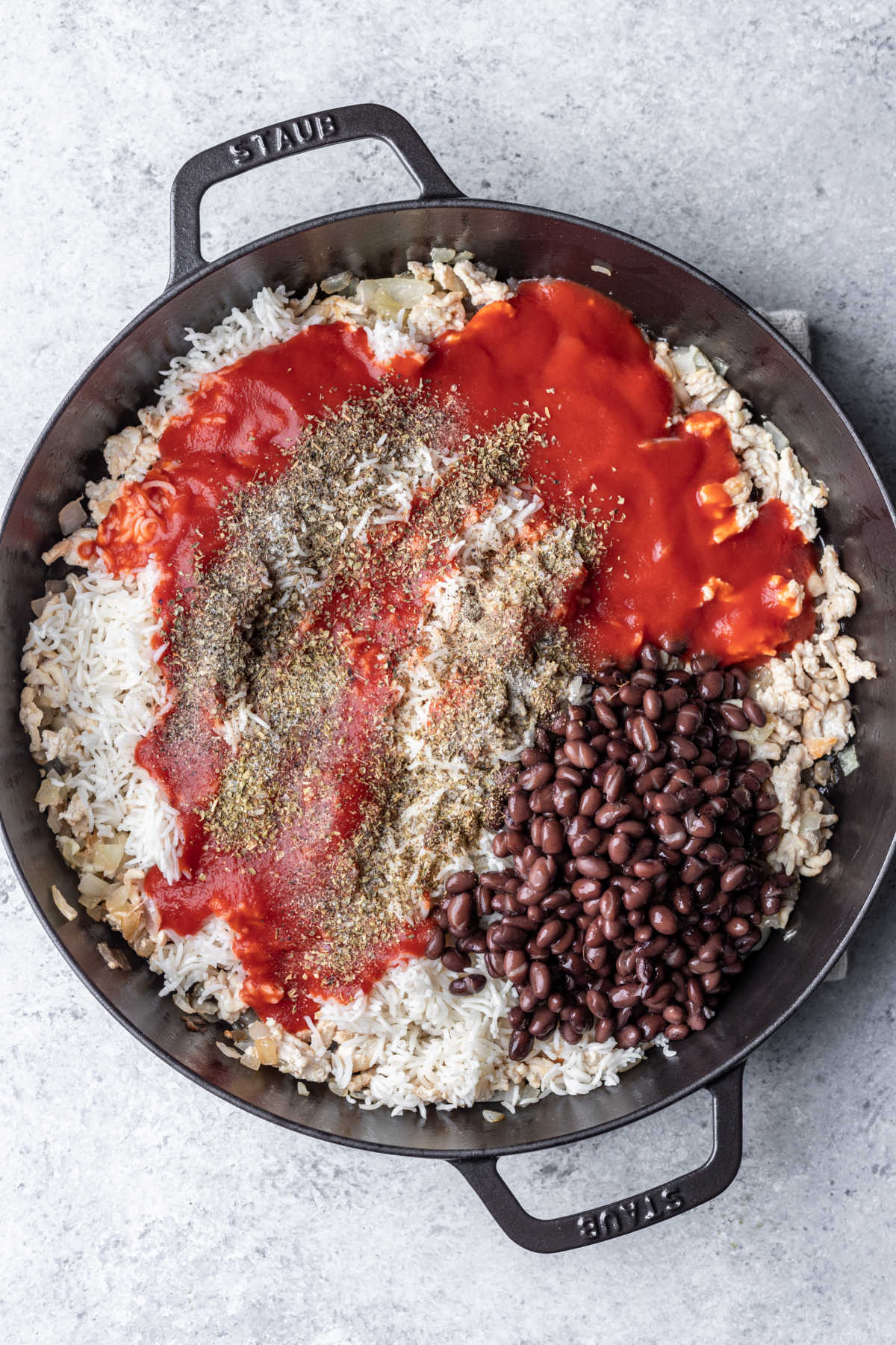 Ingredients for rice filling in a cast iron skillet.