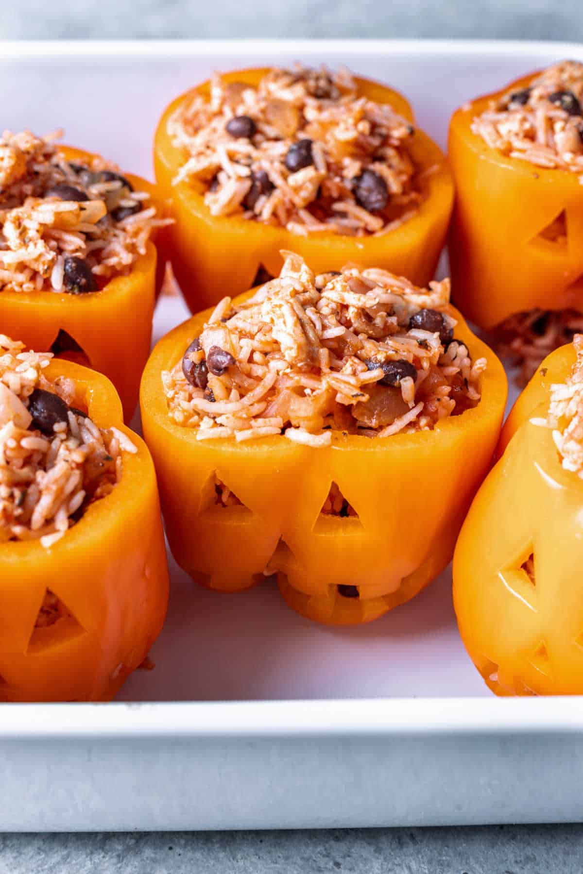 Halloween stuffed peppers in a pan.