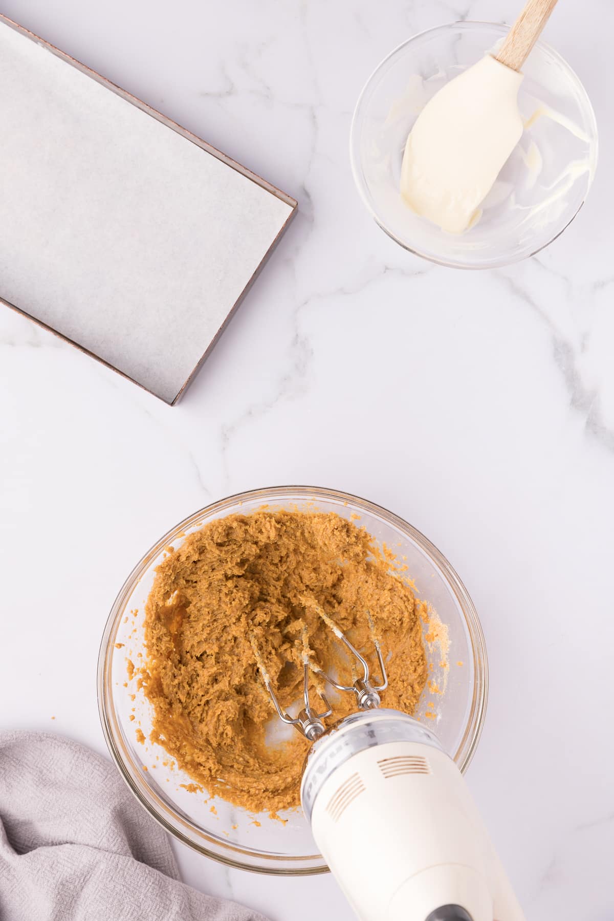 Mixer blending white chocolate into pumpkin mixture.