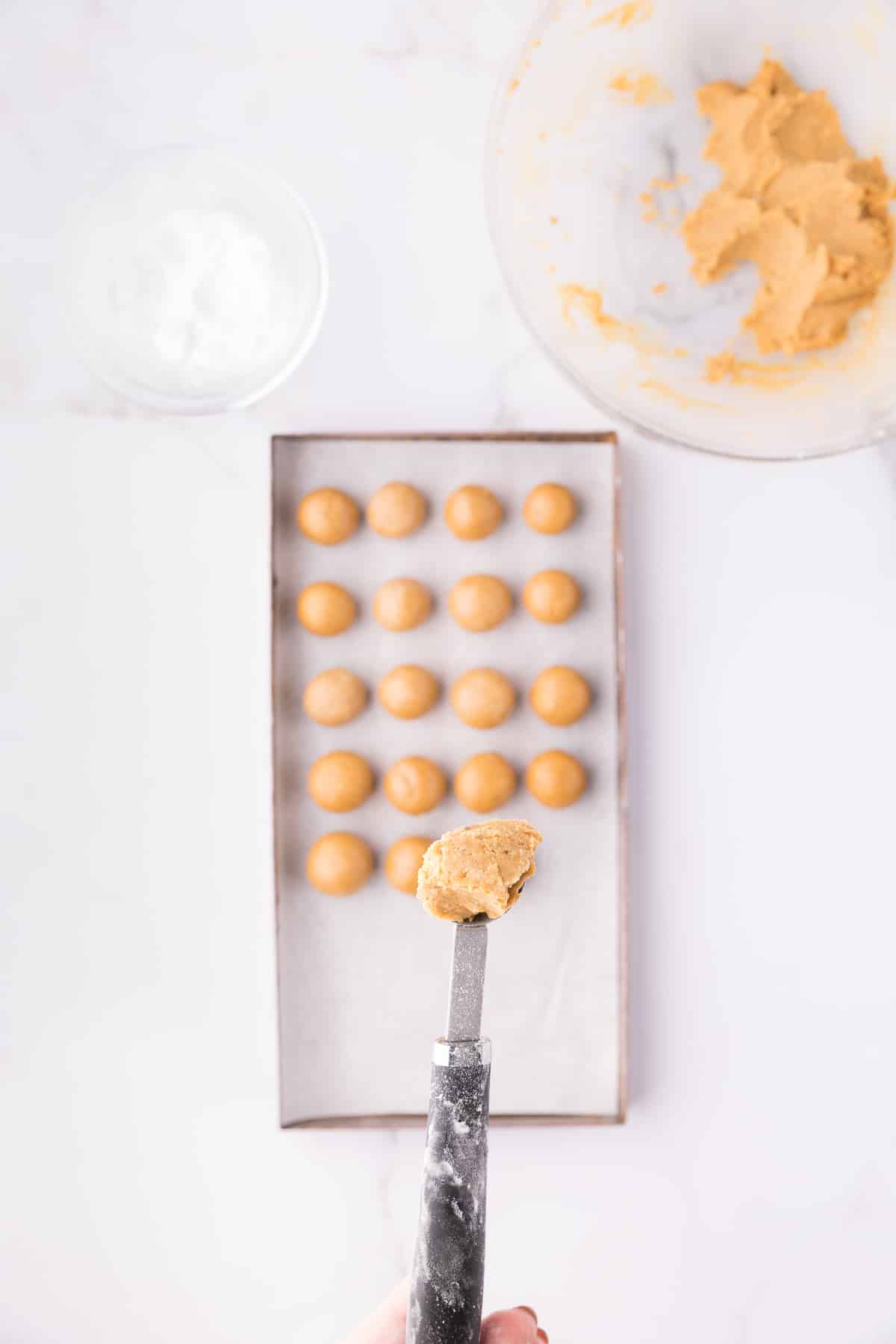 A small scoop holding pumpkin pie truffle filling.