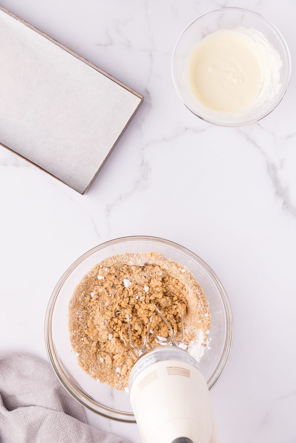 Mixer blending graham cracker crumbs into pumpkin mixture.