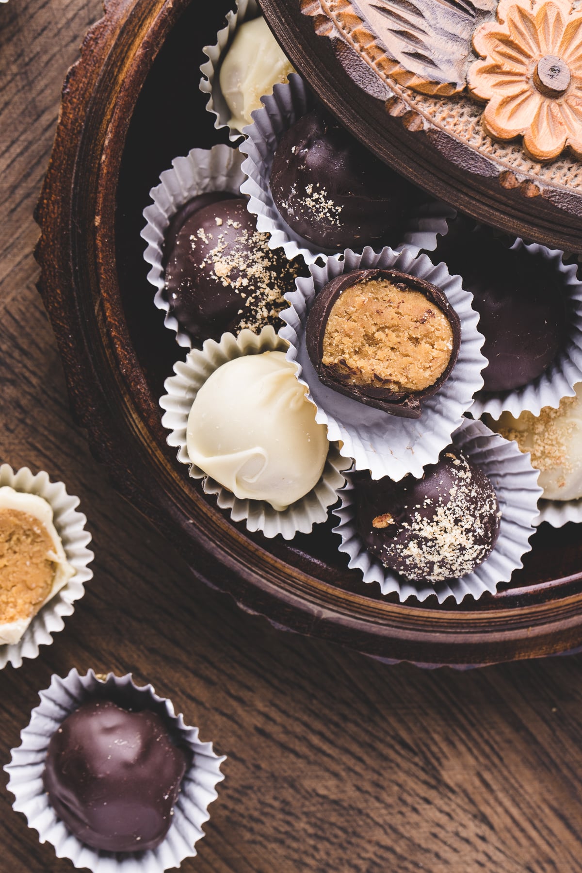Chocolate coated pumpkin pie truffle with a bite out of it.