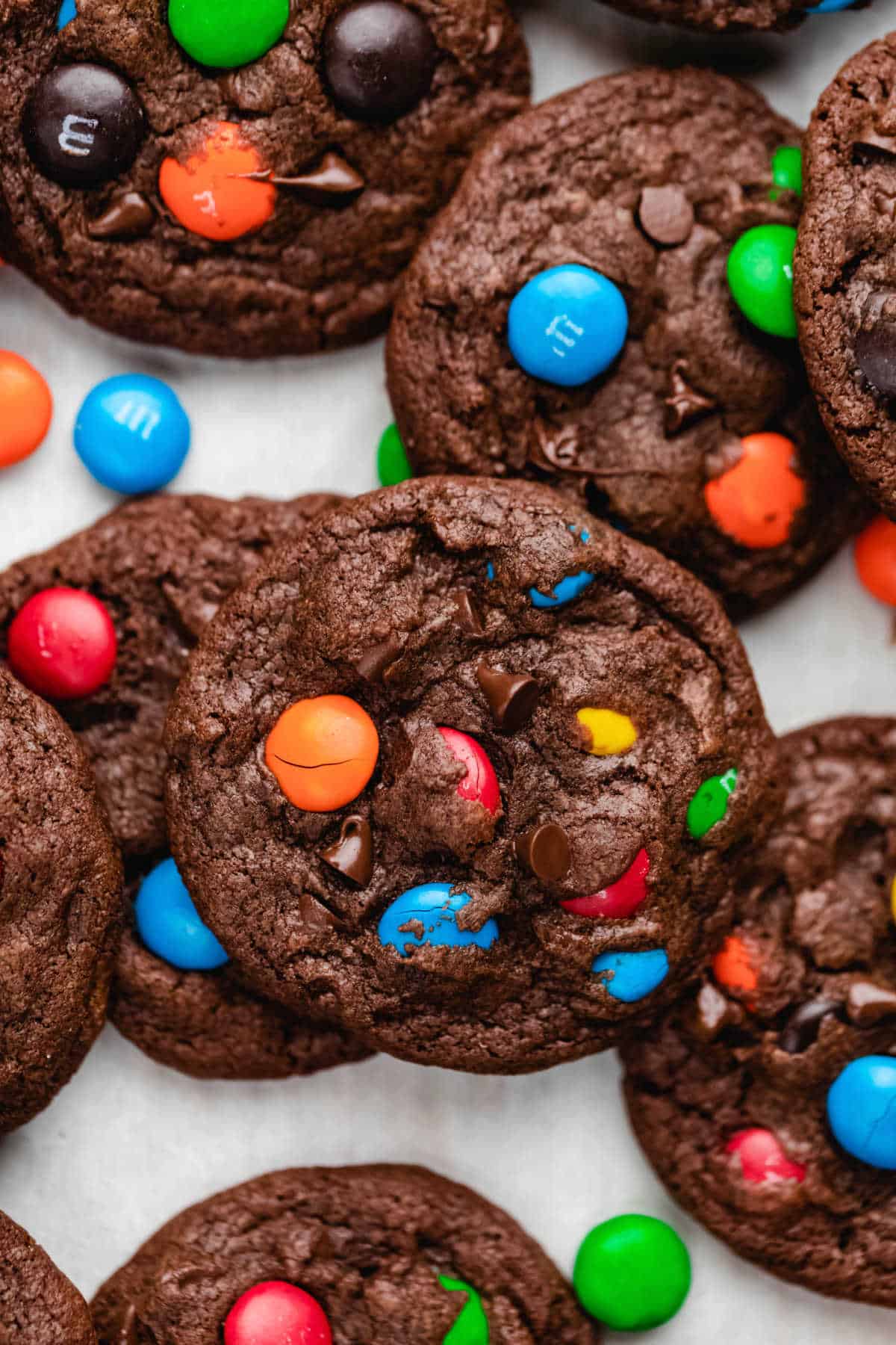 Chocolate M&M cookies in overlapping rows. 