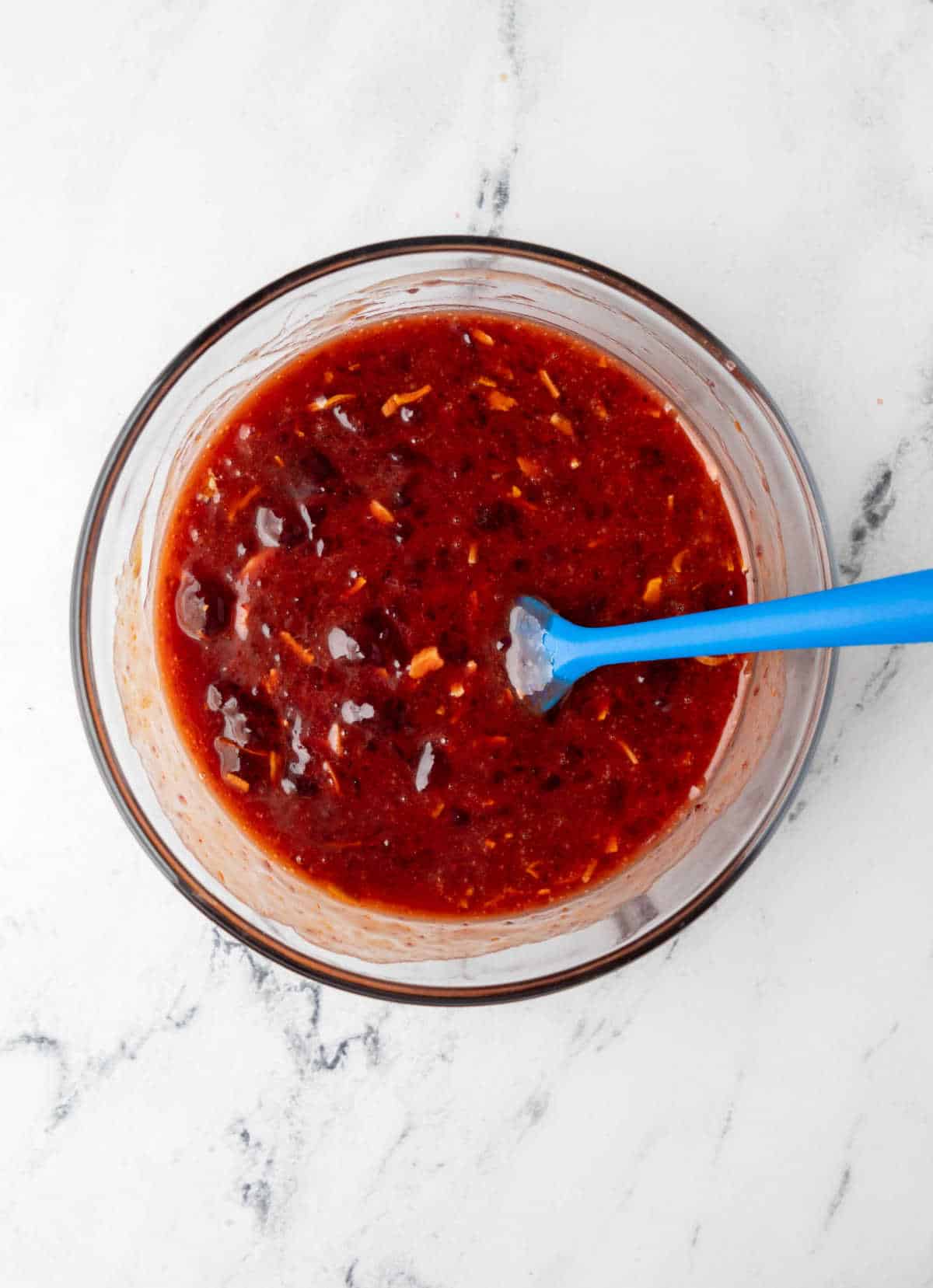 Cranberry dressing sauce in a glass mixing bowl. 