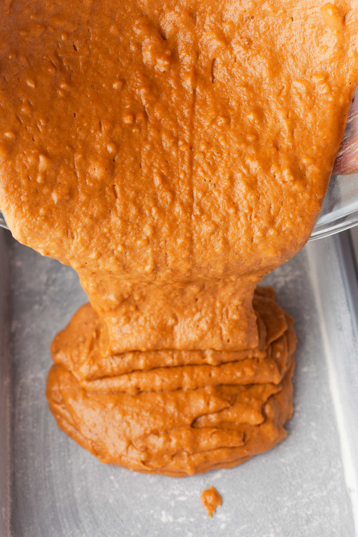 Pumpkin bar batter pouring into a pan. 