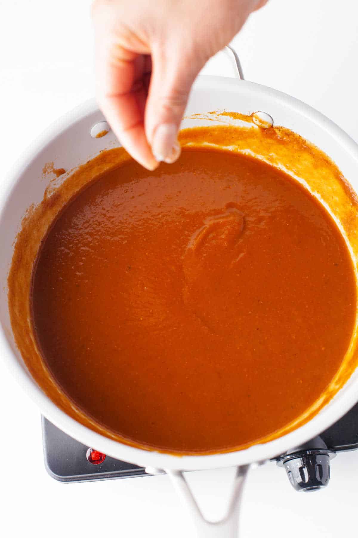 Pumpkin butter mixture cooking in a skillet. 