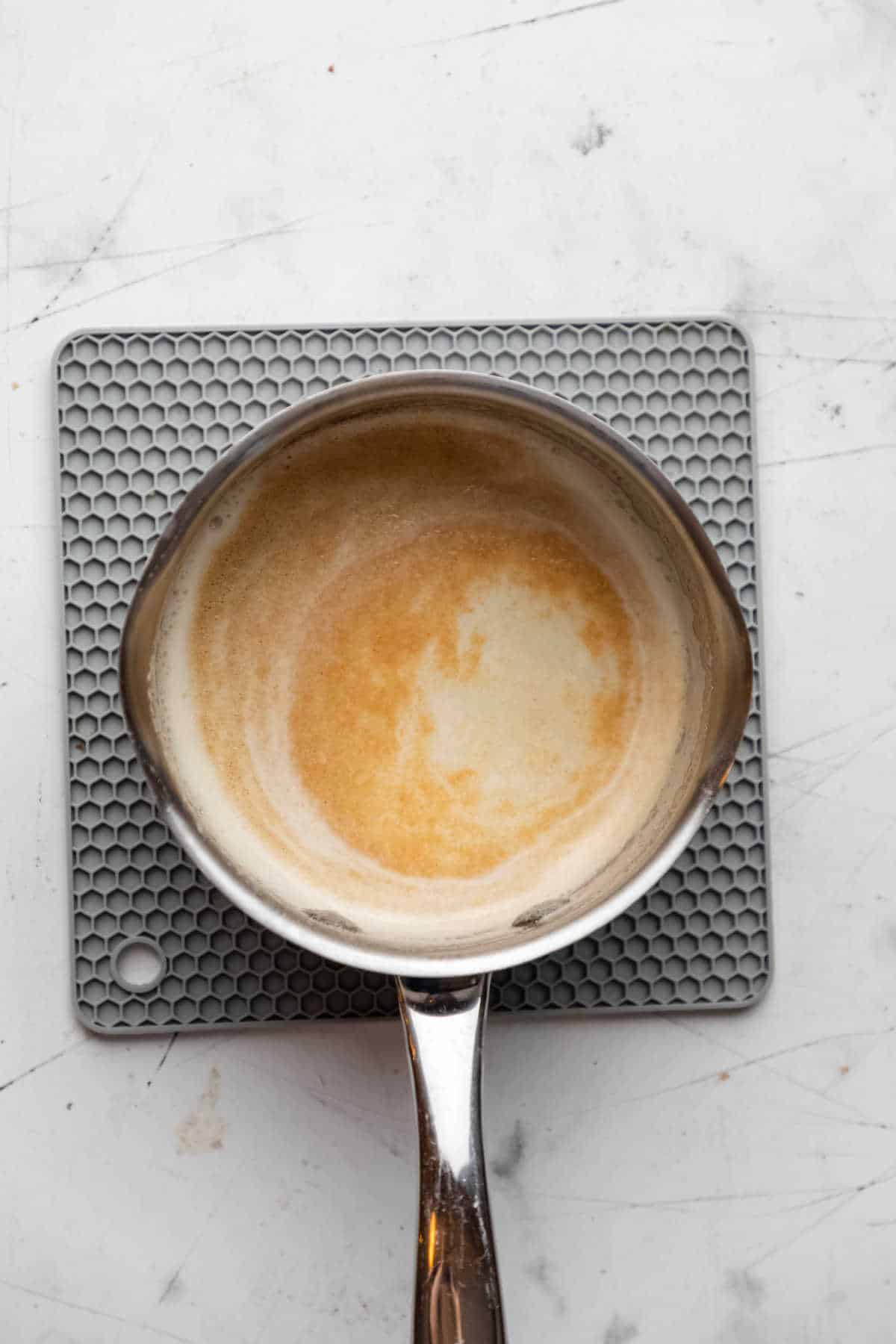 Brown butter in a small silver saucepan. 