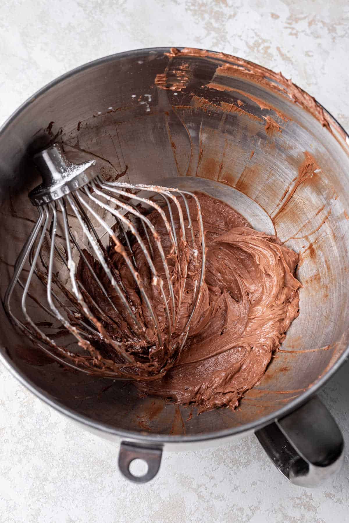 Chocolate frosting in a mixing bowl. 