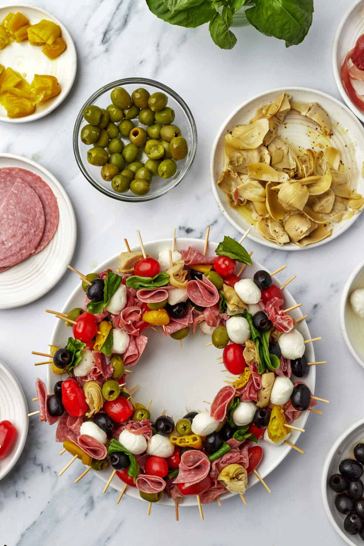 A charcuterie wreath surrounded by ingredients. 