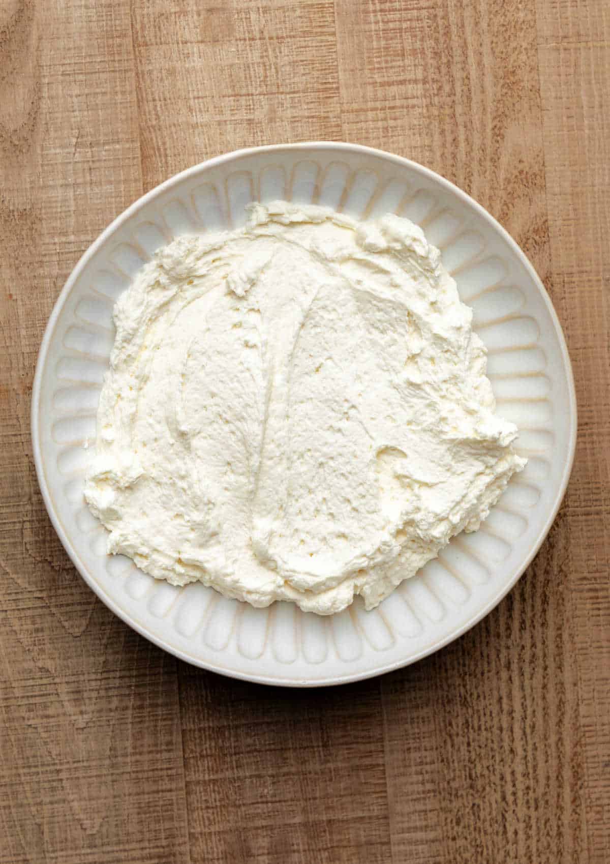 Cheesecake dip mixture in a white dish.