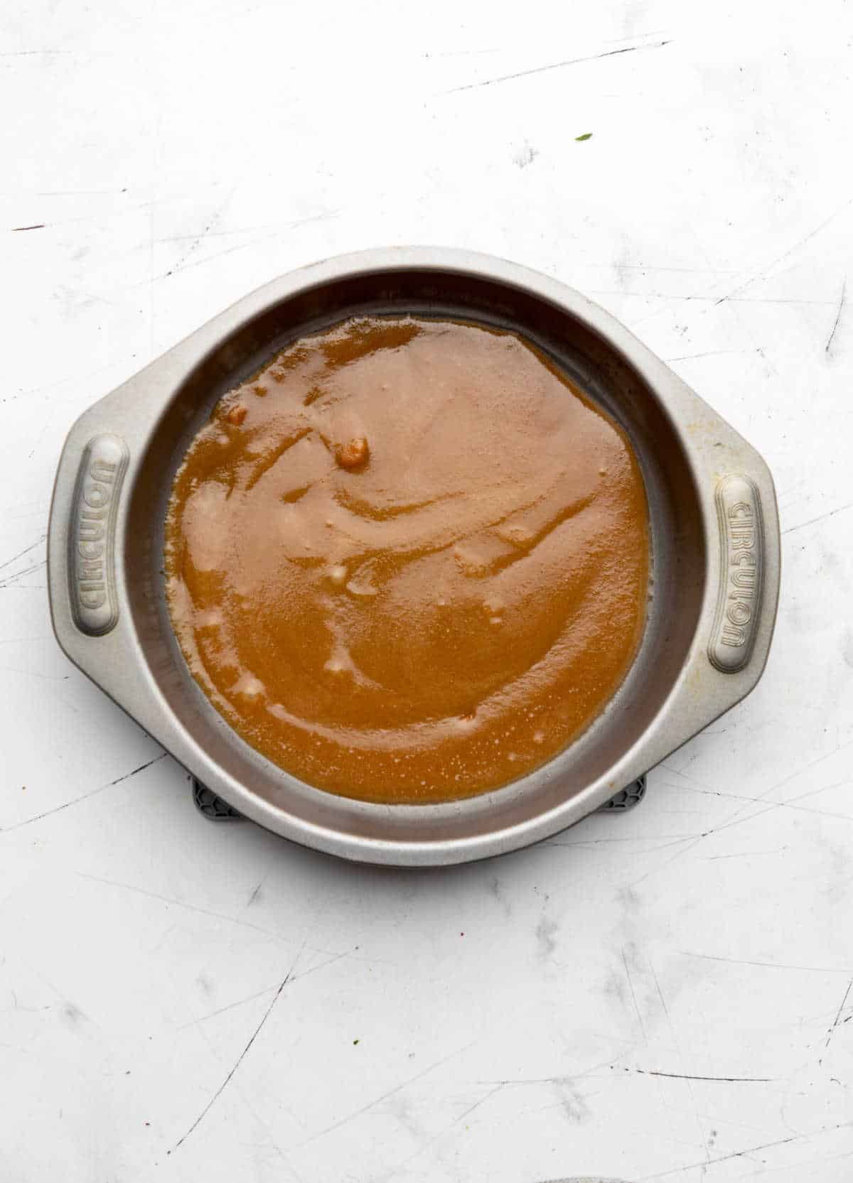 Brown sugar butter topping in a round cake pan. 