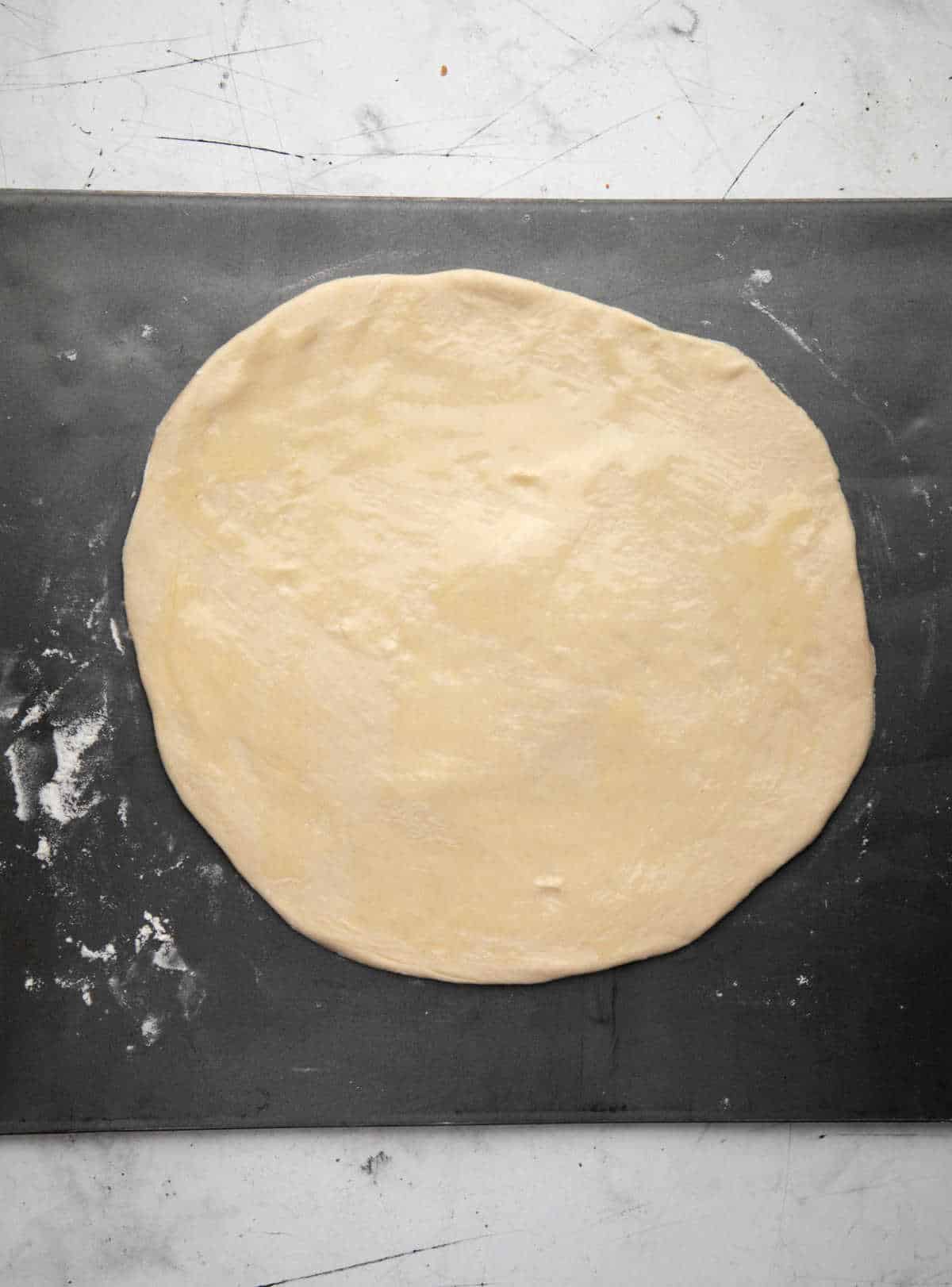 Rolled out crescent dough in a circle. 