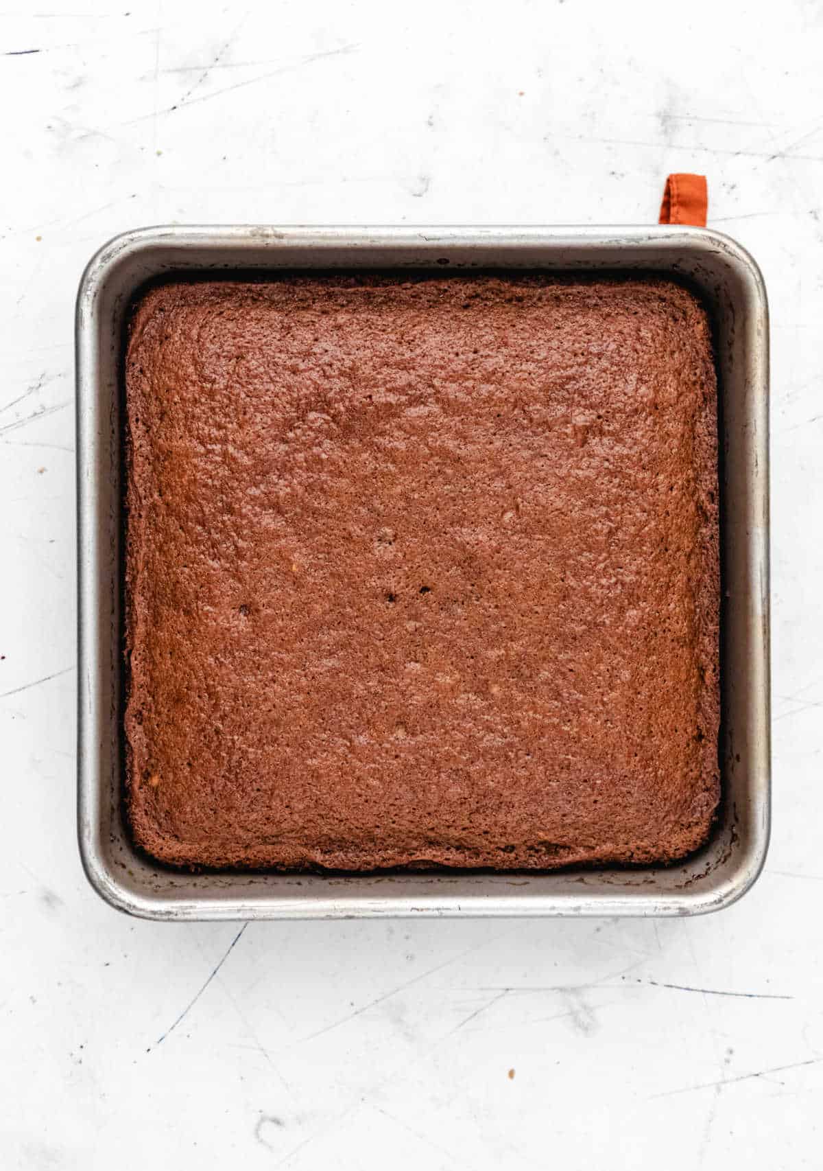 Baked sticky toffee pudding cake in a square cake pan. 