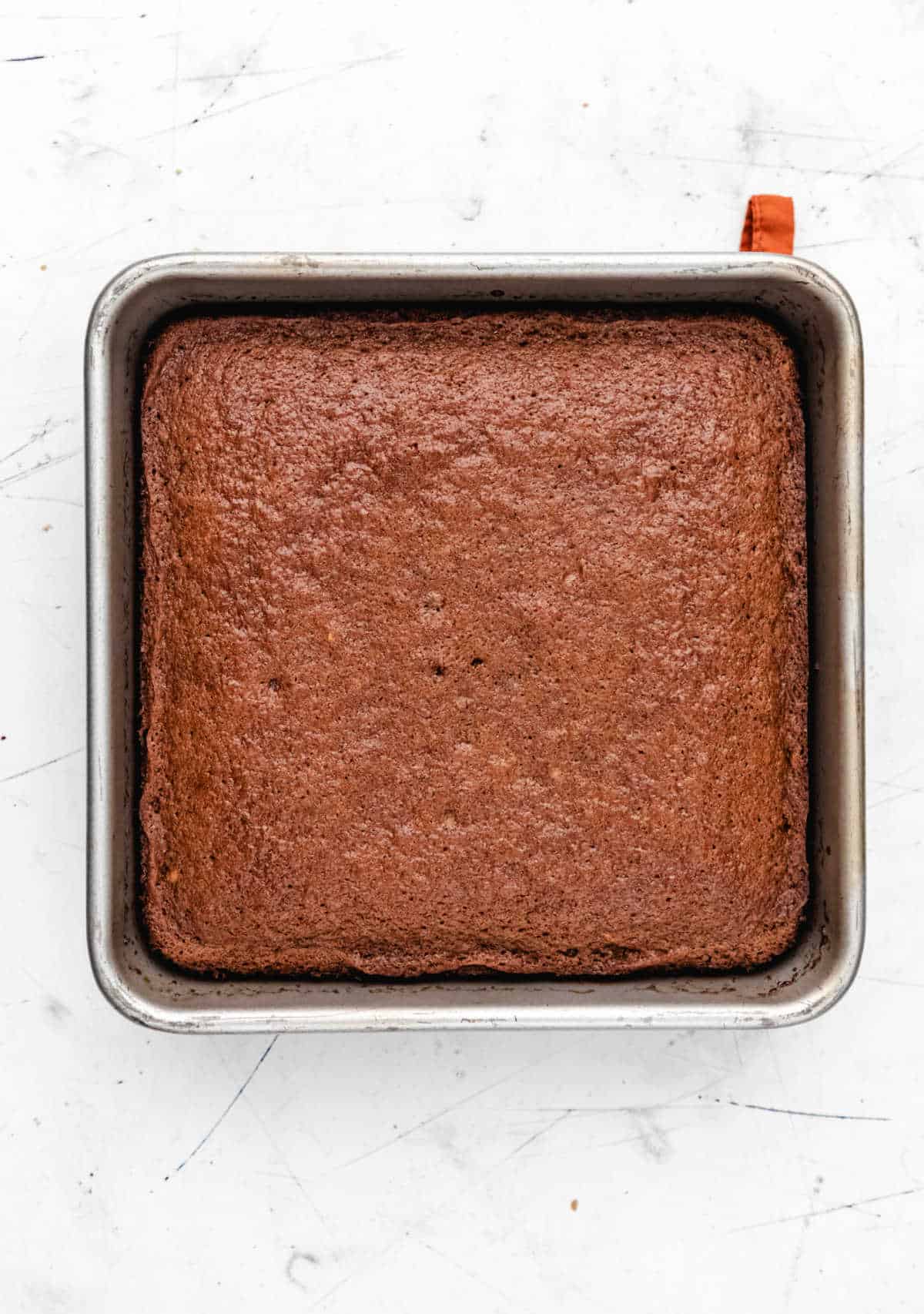 Baked sticky toffee pudding cake in a square cake pan.