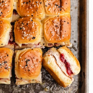 A turkey cranberry slider sideways next to rows of turkey sliders.