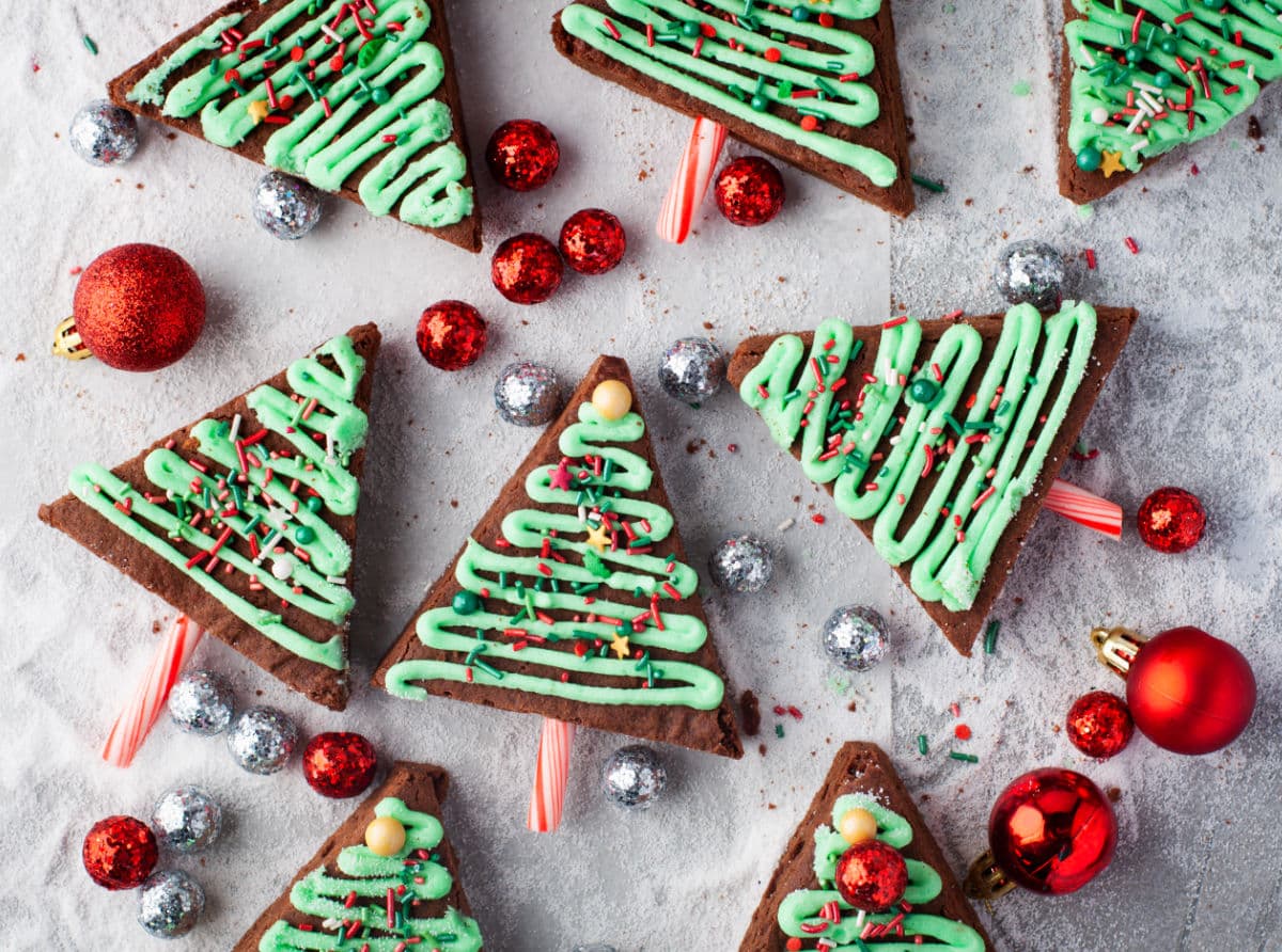 Red and silver balls around Christmas tree brownies. 