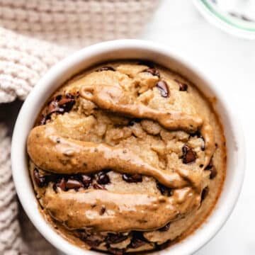 A ramekin with blended baked oats next to a tan knit napkin.