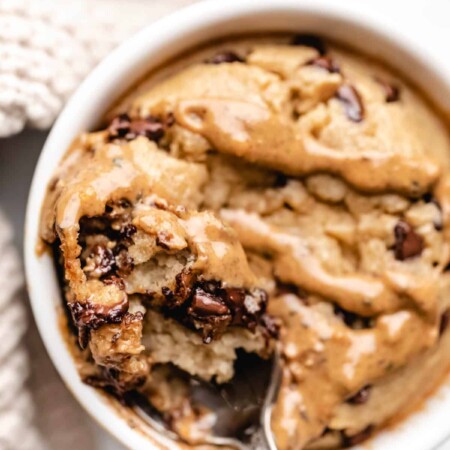 A spoon holding a bite of blended baked oats with peanut butter on it.