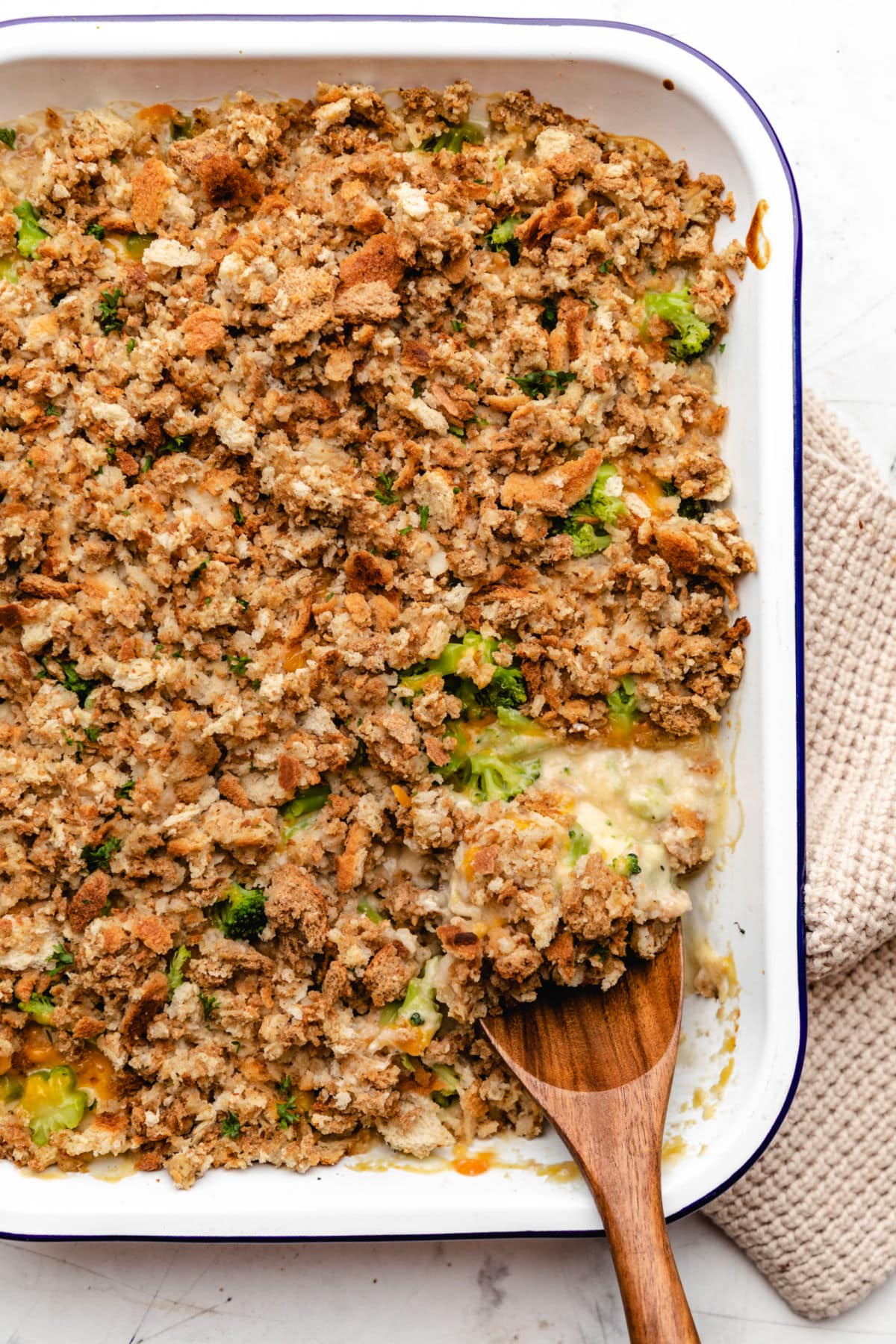 A wooden spoon in a chicken broccoli stuffing casserole.