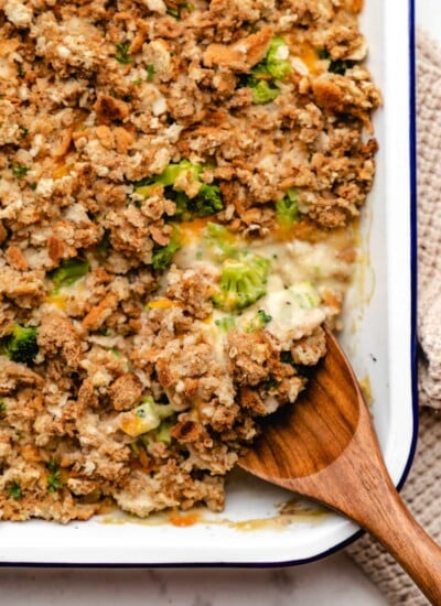A wooden spoon scooping up chicken broccoli stuffing casserole.