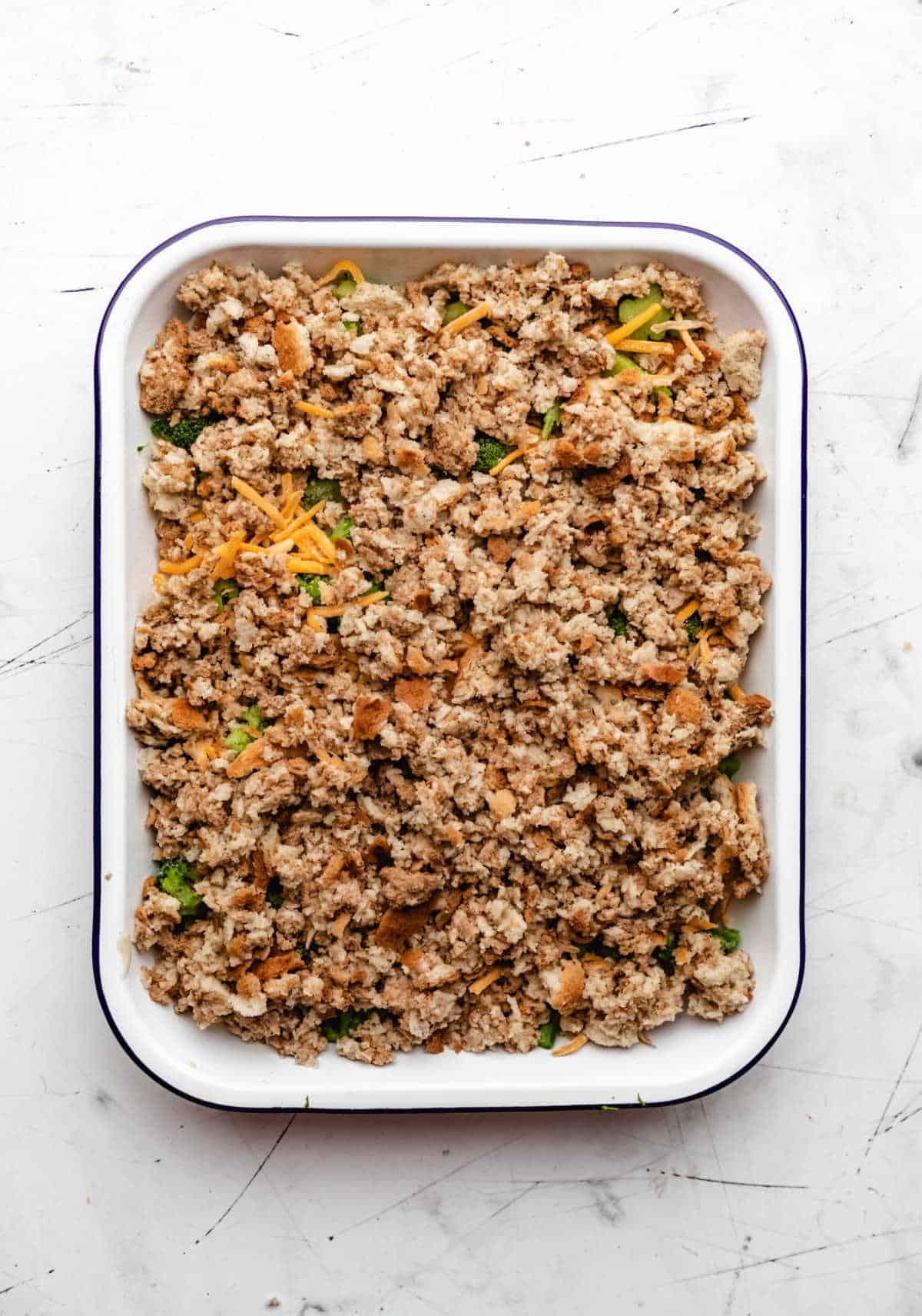 Stuffing on top of cheese in a baking pan.