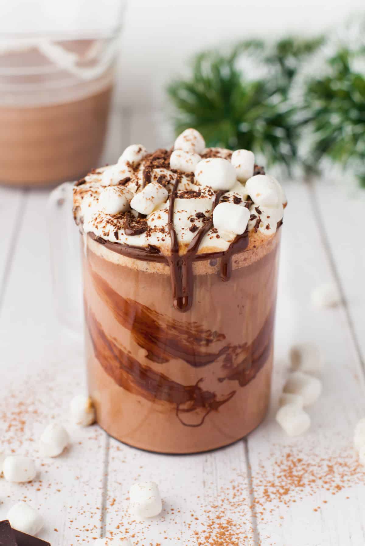 Hot chocolate mug next to marshmallows.