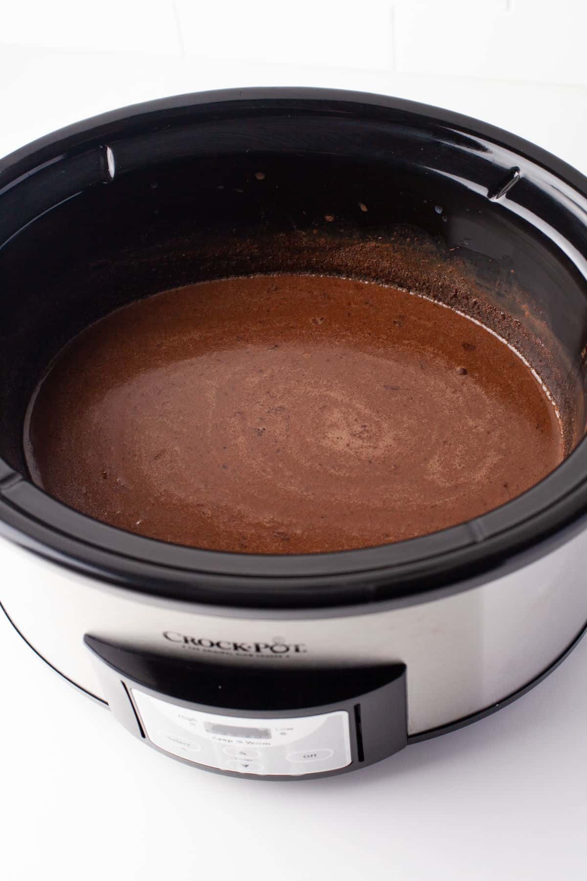 Cornstarch mixed into hot chocolate mixture in a slow cooker.