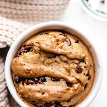 A ramekin with blended baked oats next to a tan knit napkin.