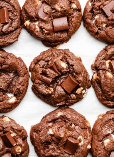 Nine hot chocolate cookies on a piece of parchment paper.