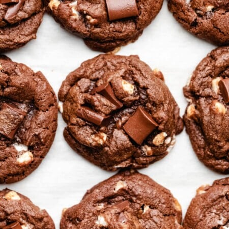 Nine hot chocolate cookies on a piece of parchment paper.