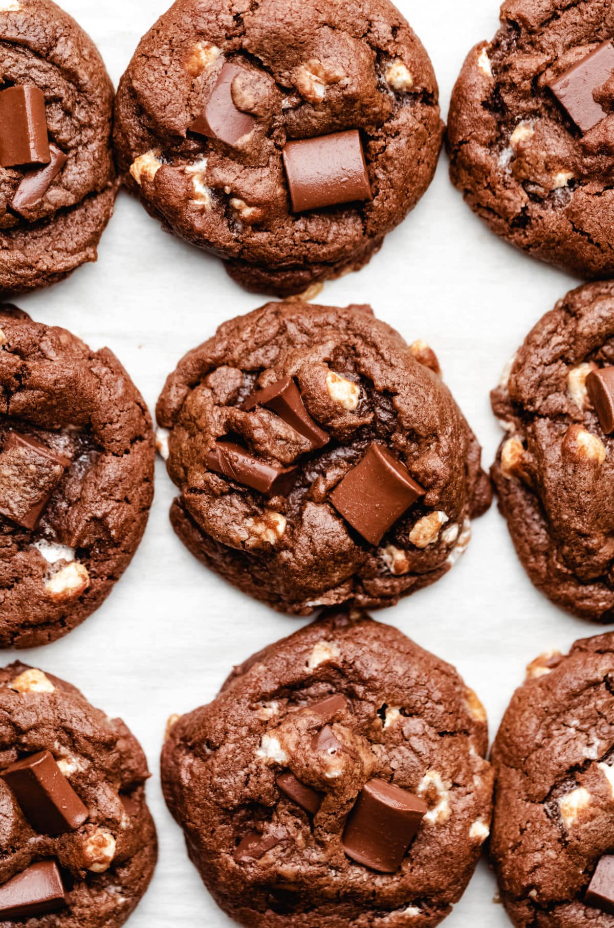 Nine hot chocolate cookies on a piece of parchment paper. 