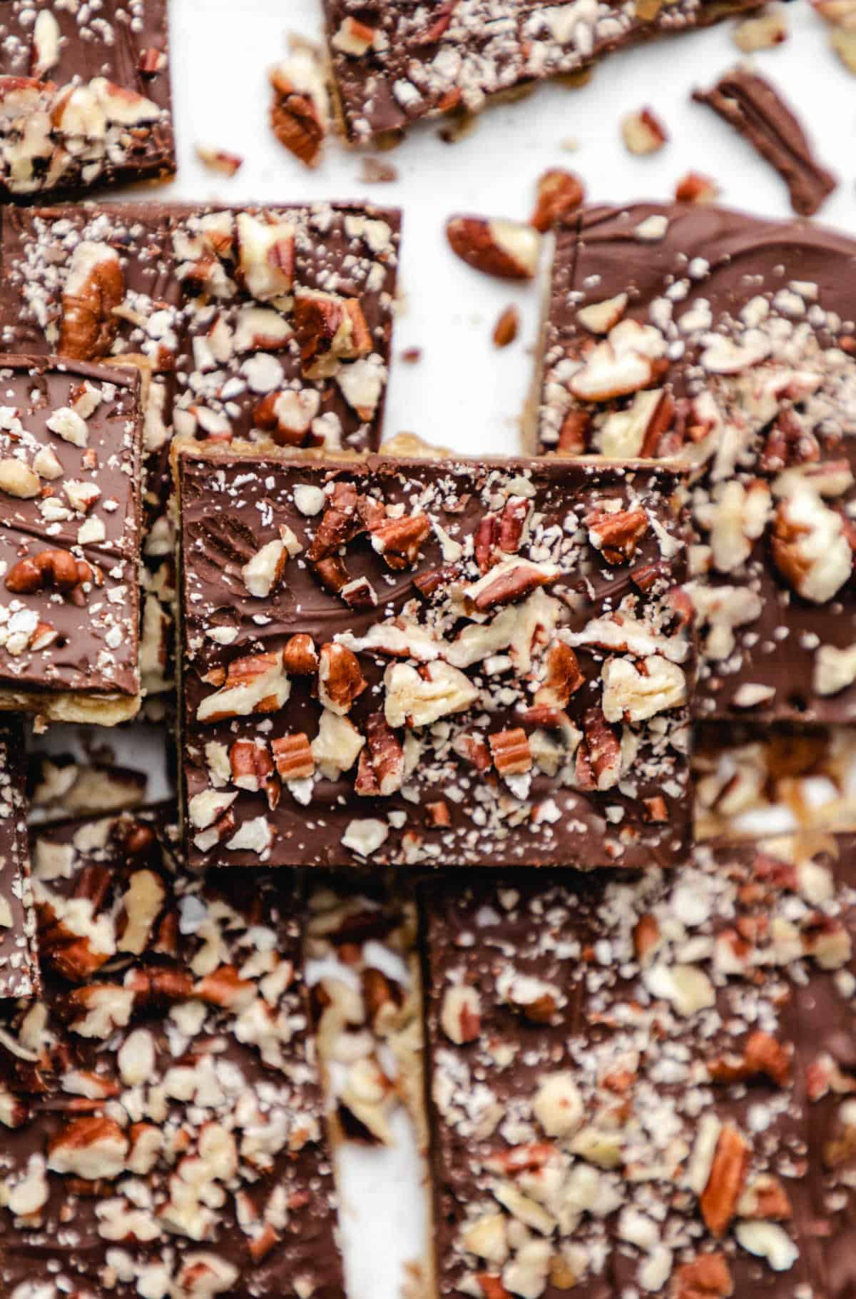 A piece of saltine toffee stacked on top of other pieces of toffee.