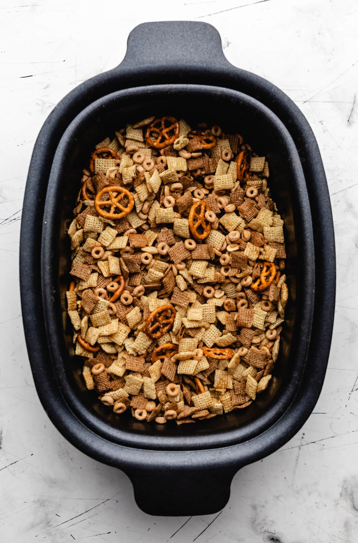 Chex mix in an slow cooker insert. 